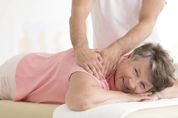 Massaggiatore impostazione anziana donna spalla — Foto Stock