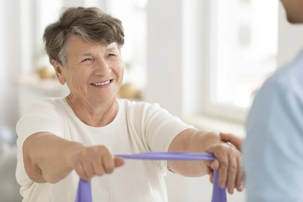 Senior woman with elastic band — Stock Photo, Image