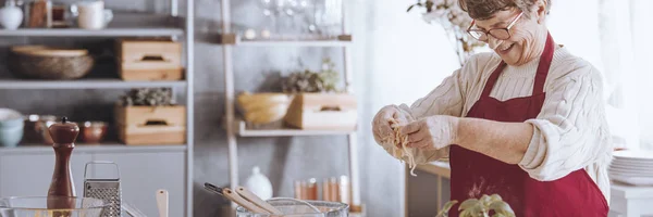 Femme âgée gaie préparant des pâtes — Photo