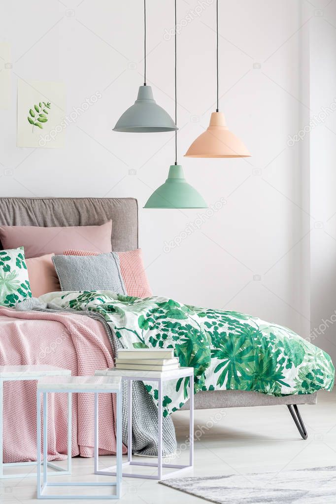 Pastel lamps above king-size bed