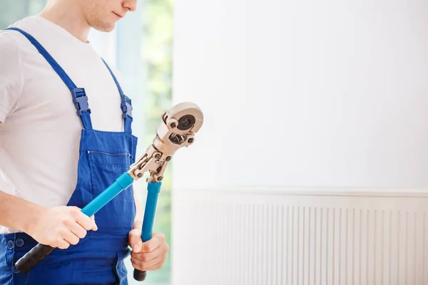 Handyman holding professional wrench — Stock Photo, Image