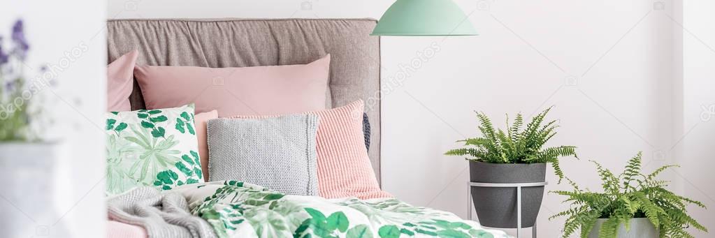 Green lamp above king-size bed