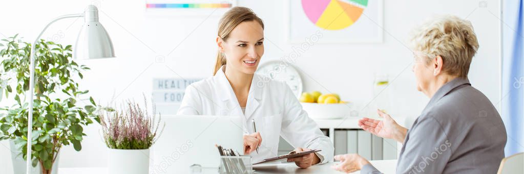 Smiling nutritionist making notes