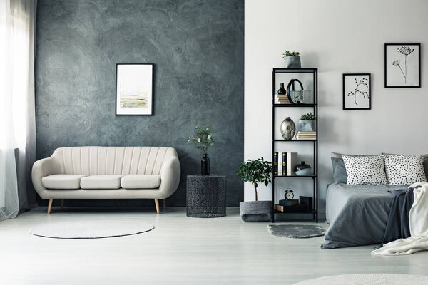 Elegant sofa by grey wall