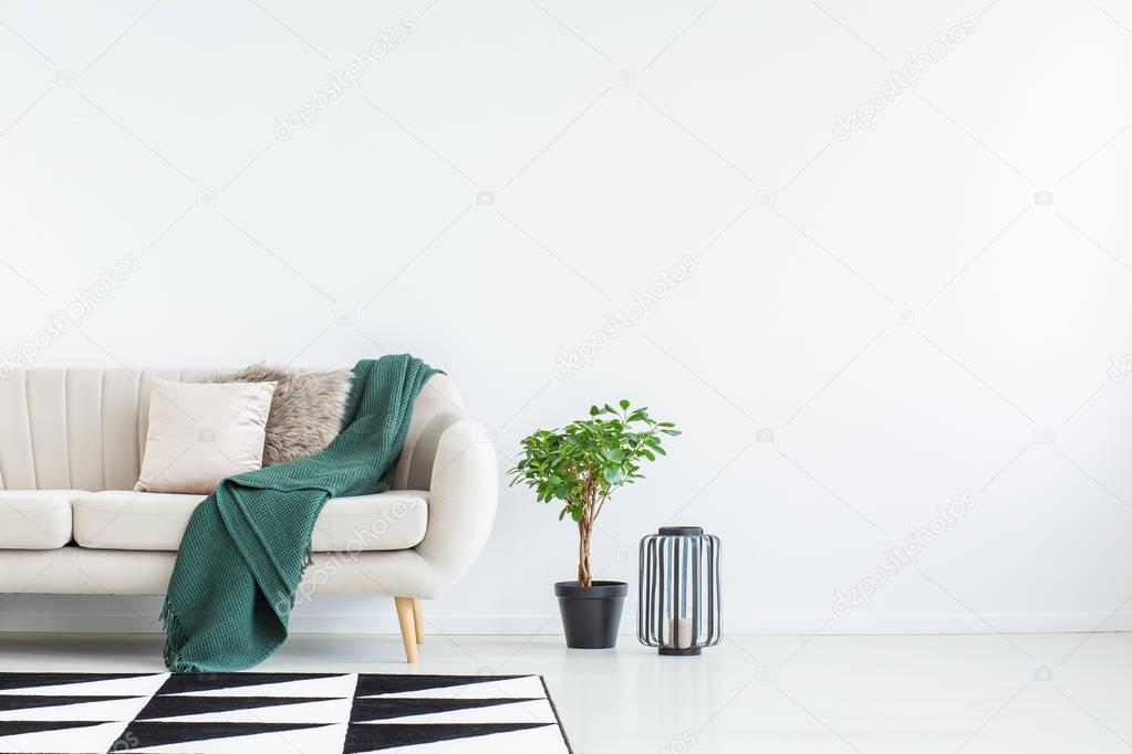 Sofa against empty wall