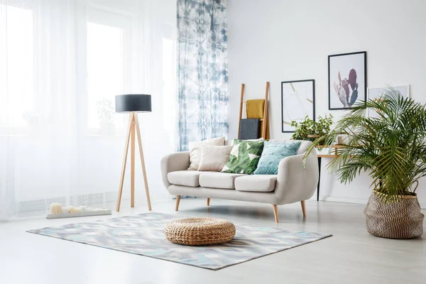 Black lamp standing by sofa — Stock Photo, Image