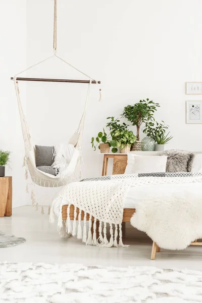 Бежевое одеяло на деревянной кровати — стоковое фото
