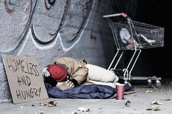 Dirty tramp lying on blanket — Stock Photo, Image