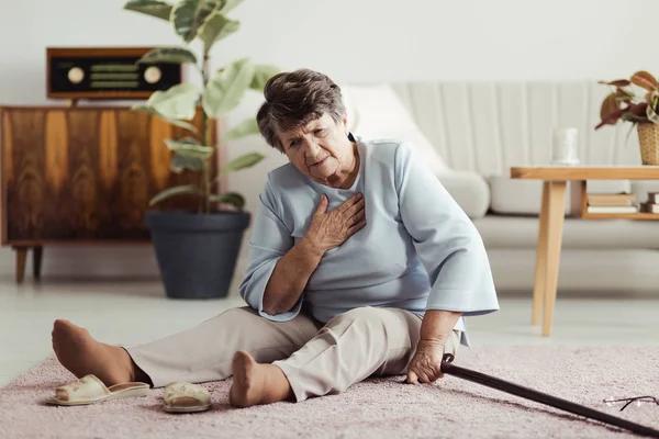 Disabled elder on the floor — Stock Photo, Image
