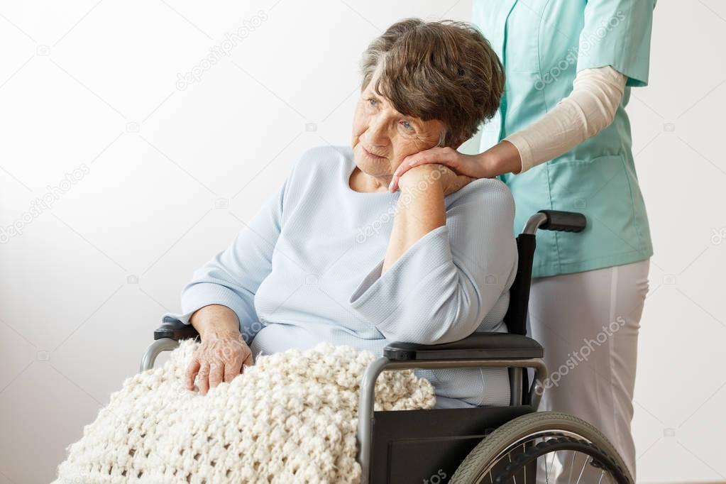 Sad disabled senior woman