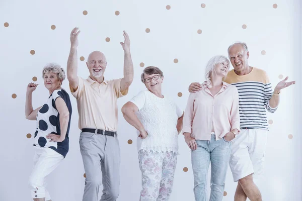 Elderly friends dancing and talking — Stock Photo, Image