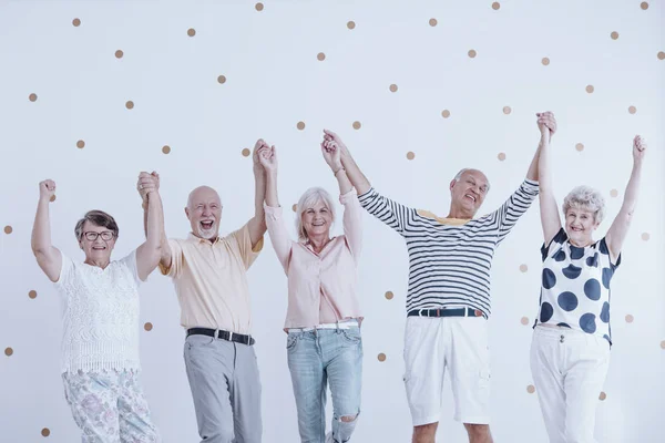 Seniores felizes pulando — Fotografia de Stock