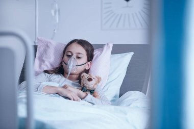 Sick child with oxygen mask clipart