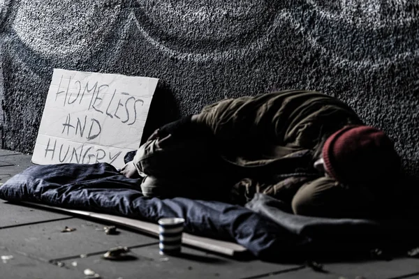 Homeless sleeping on ground — Stock Photo, Image