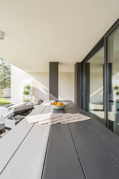 Wooden table on terrace — Stock Photo, Image