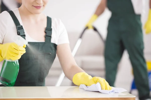 Cleaning lady spraying table — Stock Photo, Image