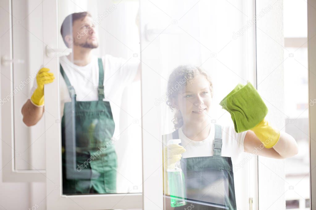 Professional cleaners cleaning windows