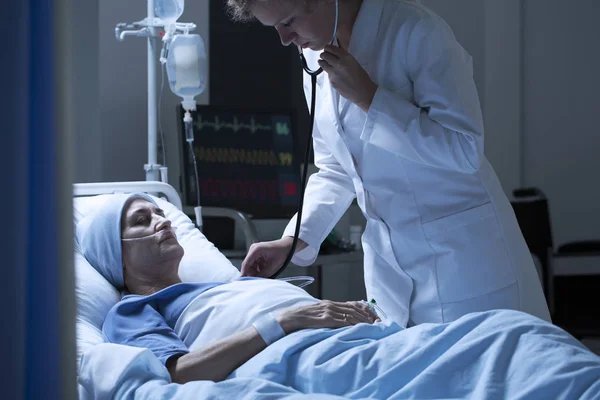 Médico examinando mujer enferma —  Fotos de Stock