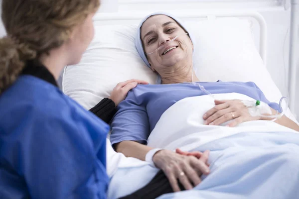 Woman enjoying visit of caregiver — Stock Photo, Image