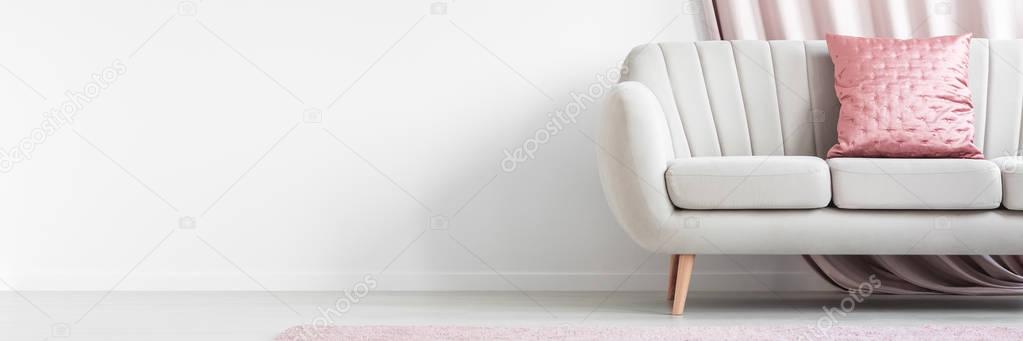 Pink pillow on beige couch