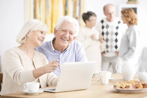 Casal de idosos sentado no laptop — Fotografia de Stock