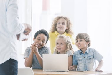 Sınıfları programlama sırasında gülümseyen çocuklar