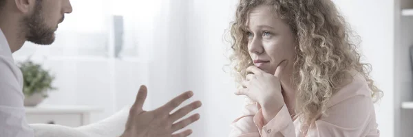 Smiling woman listening to counselor