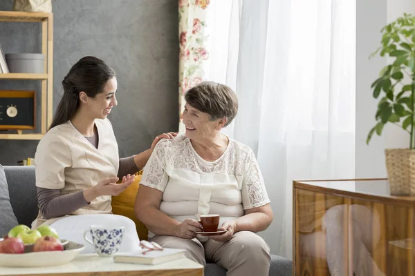 Lächelnde Großmutter trinkt Tee — Stockfoto