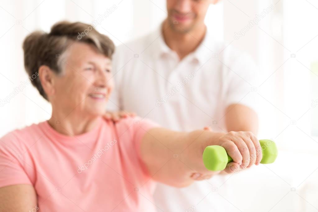 Senior woman exercising with dumbbell
