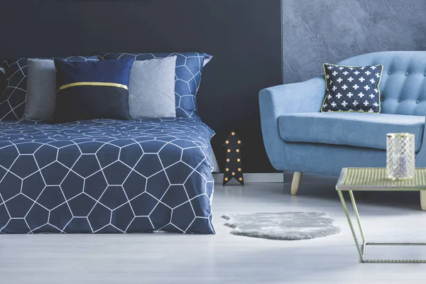 Blue sofa in cozy bedroom