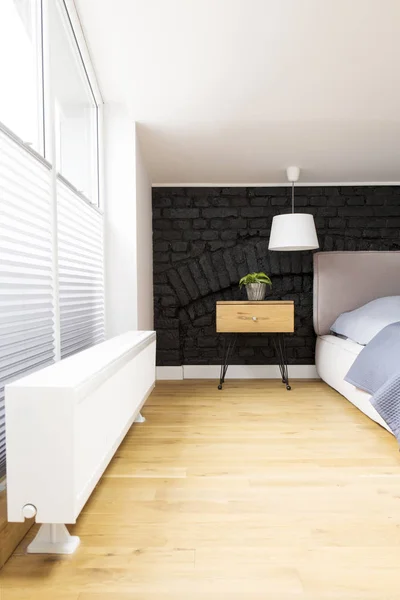 Wooden bedroom with brick wall — Stock Photo, Image