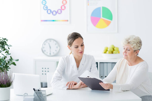 Dietician showing personalized diet plan 