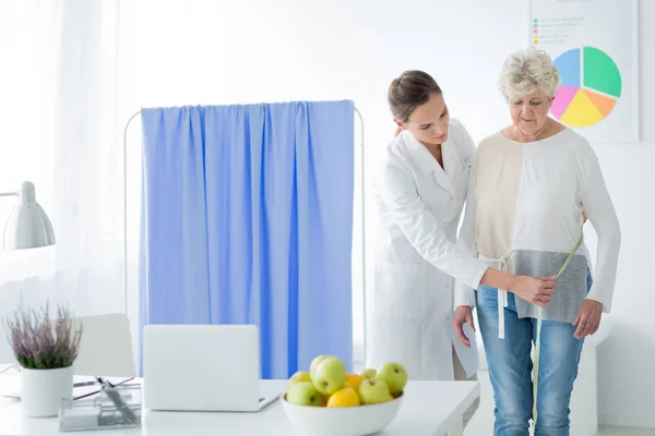 Dietician measuring woman's body circuit — Stock Photo, Image