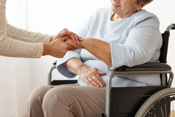 Family member supporting disabled grandmother — Stock Photo, Image