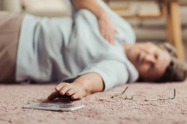 Senior person reaching for phone — Stock Photo, Image