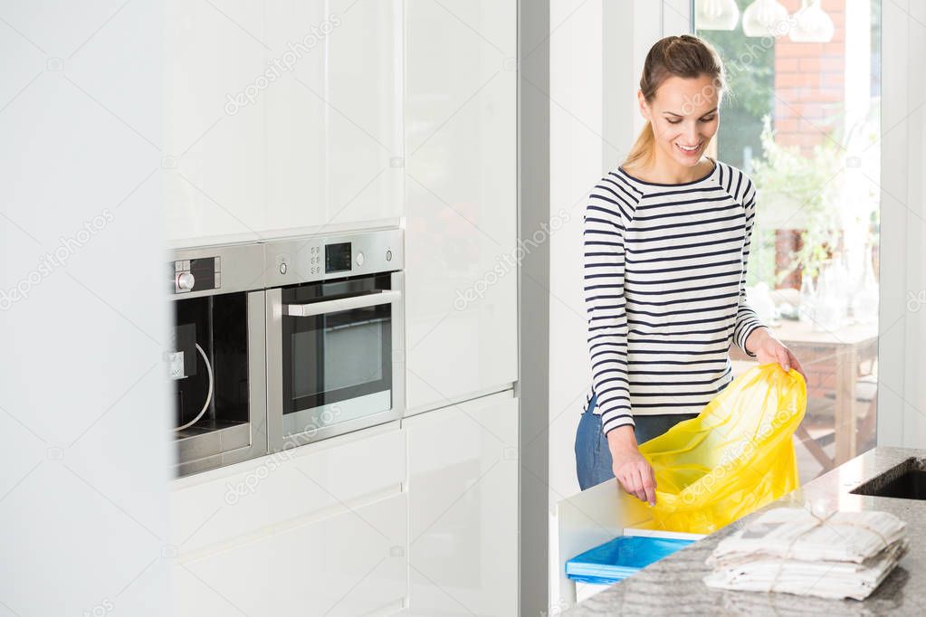 Woman preparing bin for segregation