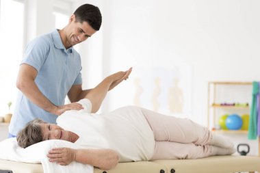 Senior rehabilitation with physiotherapist clipart