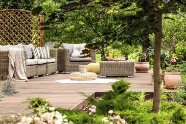 Garden furniture on wooden patio clipart
