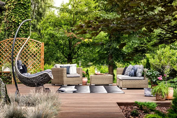 Hanging chair on wooden patio — Stock Photo, Image