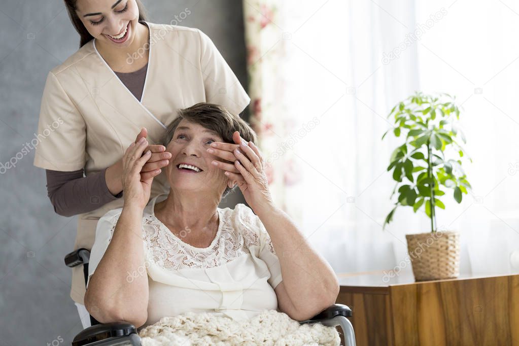 Nurse surprising a senior patient in a nursing home