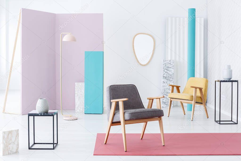 Modern furniture and accessories still life composition in a fun bright interior with pink, blue and marble elements and armchairs