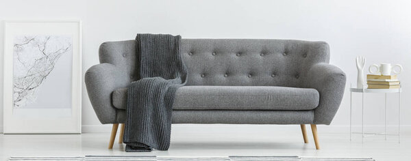 Grey couch with blanket