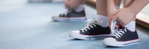 Close-up of kid tying shoes — Stock Photo, Image