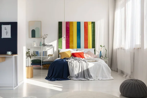 Colorful bedroom interior with rainbow colored bedhead — Stock Photo, Image