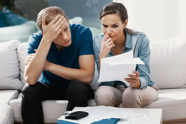 Stressed married couple looking frustrated, having no money to pay off their debts, managing family budget together — Stock Photo, Image