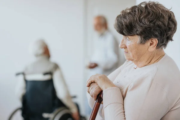 Woman with walking stick — Stock Photo, Image