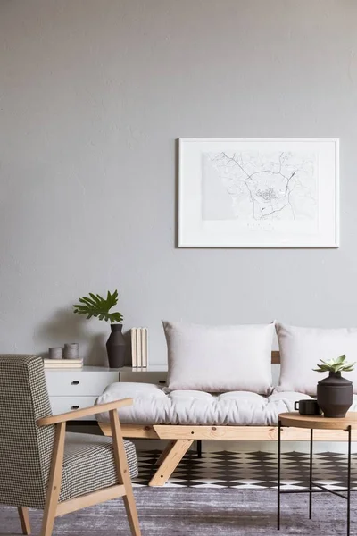 White map on grey wall in fashionable living room interior with scandinavian futon