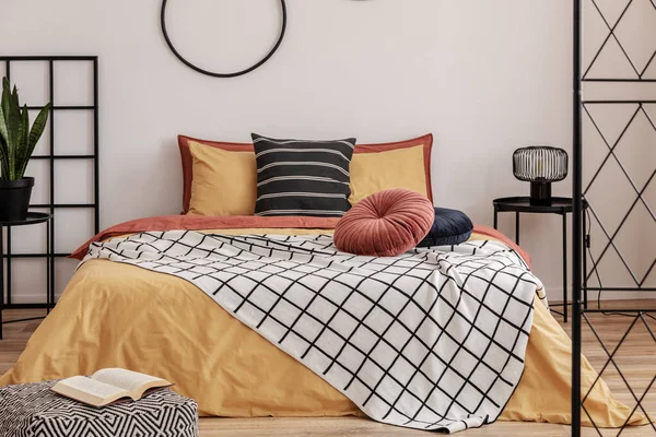 床上挂着橙色床上用品的雅致卧室 白色墙上的黑色圈圈 — 图库照片