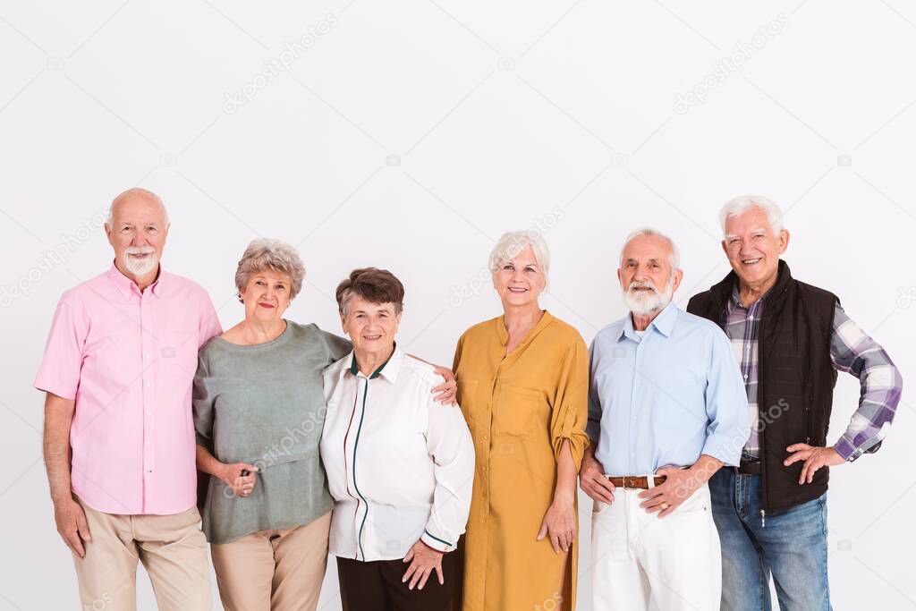 White interior with group of senior happy people in casual cloths