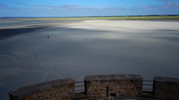 Julay, 2019, France, Mont Saint-Michel is an island-fortress city on the coast. The surrounding desert at low tide and the shadow of a passing cloud — 비디오